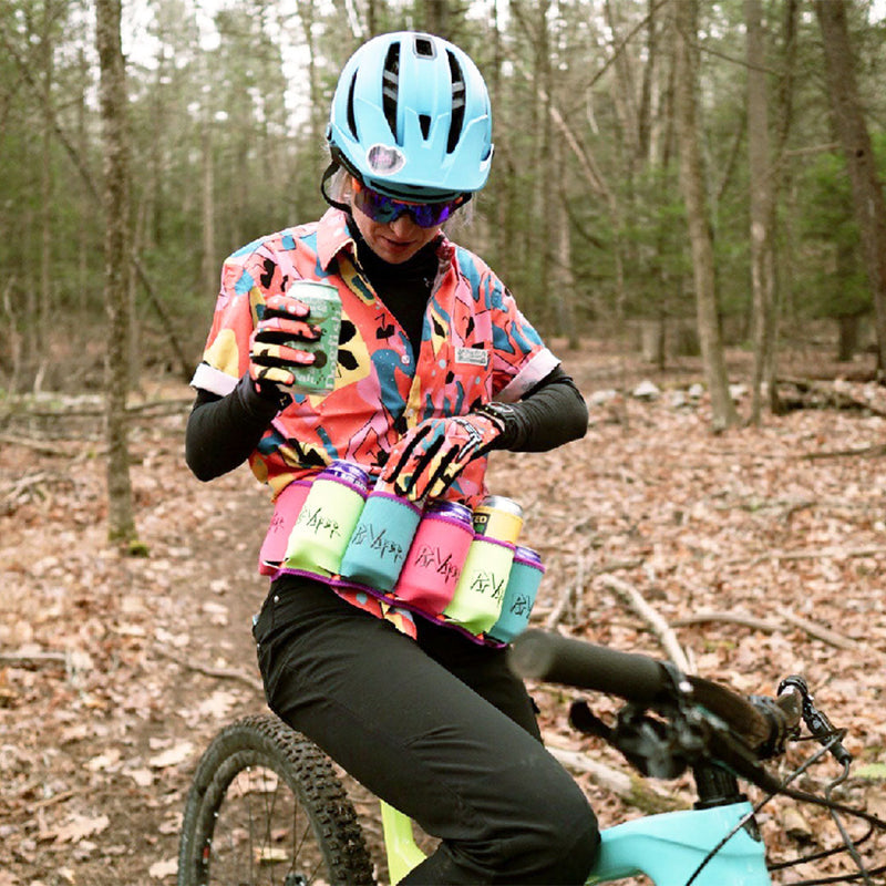  | lifestyle_on_bike.JPG | Woman on a mountain bike in the woods wearing The Butt Bar Beer Belt Dayman filled with cans