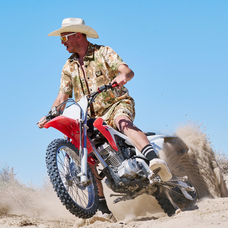  | photo_of_person_2.JPG | Man on a dirt bike wearing a cowboy hat and The Actualbush Sport Denim Button Down Shirt from Pit Viper
