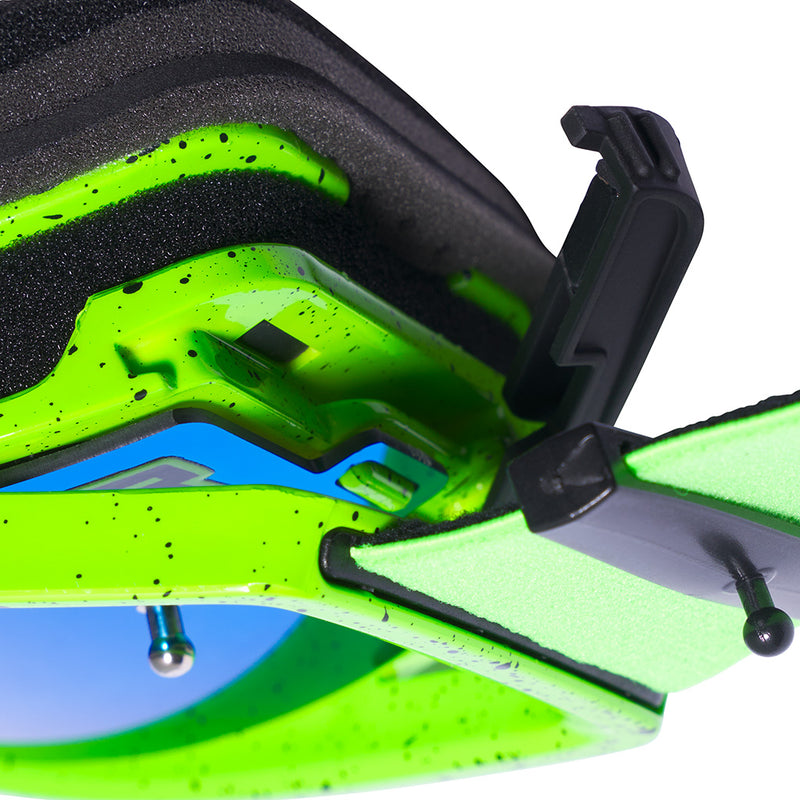 Close-up of a green goggles lens latching mechanism