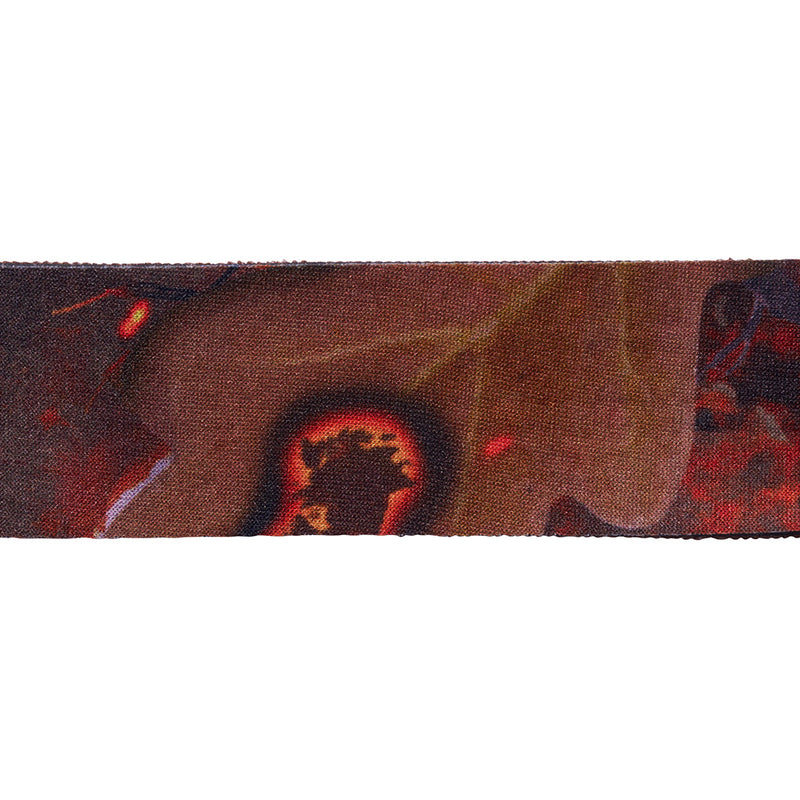 | wowee.JPG | A close-up horizontal view of a woven textile or strap featuring an abstract pattern in dark brown, black, red, and beige tones.