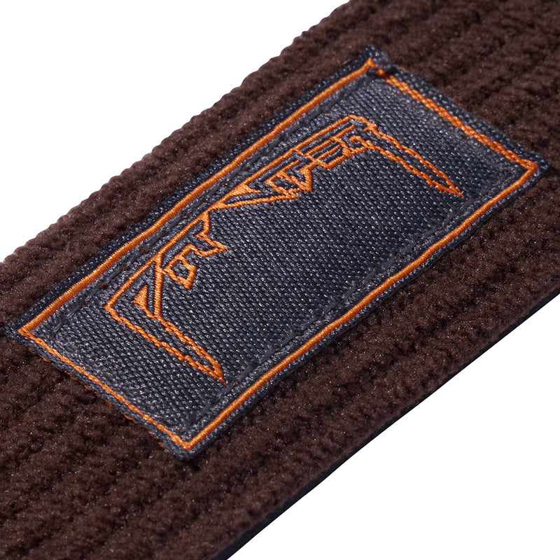 Close-up of a dark brown textured knit strap with a rectangular navy blue woven label outlined in orange stitching and orange embroidered lettering.